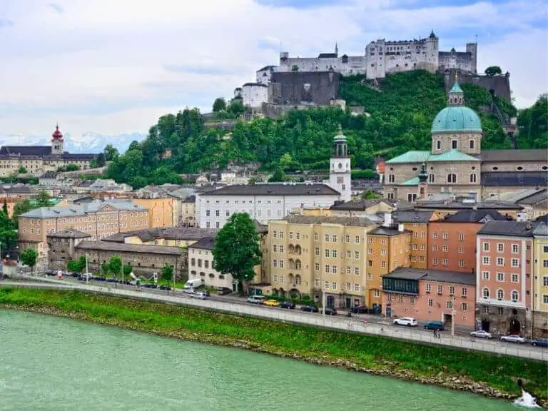 salzburg landscape showing the salzach river and baroque architecture of the old town along towering hohensalzburg fortress in a featured image for 1, 2, and 3 day itinerary salzburg austria