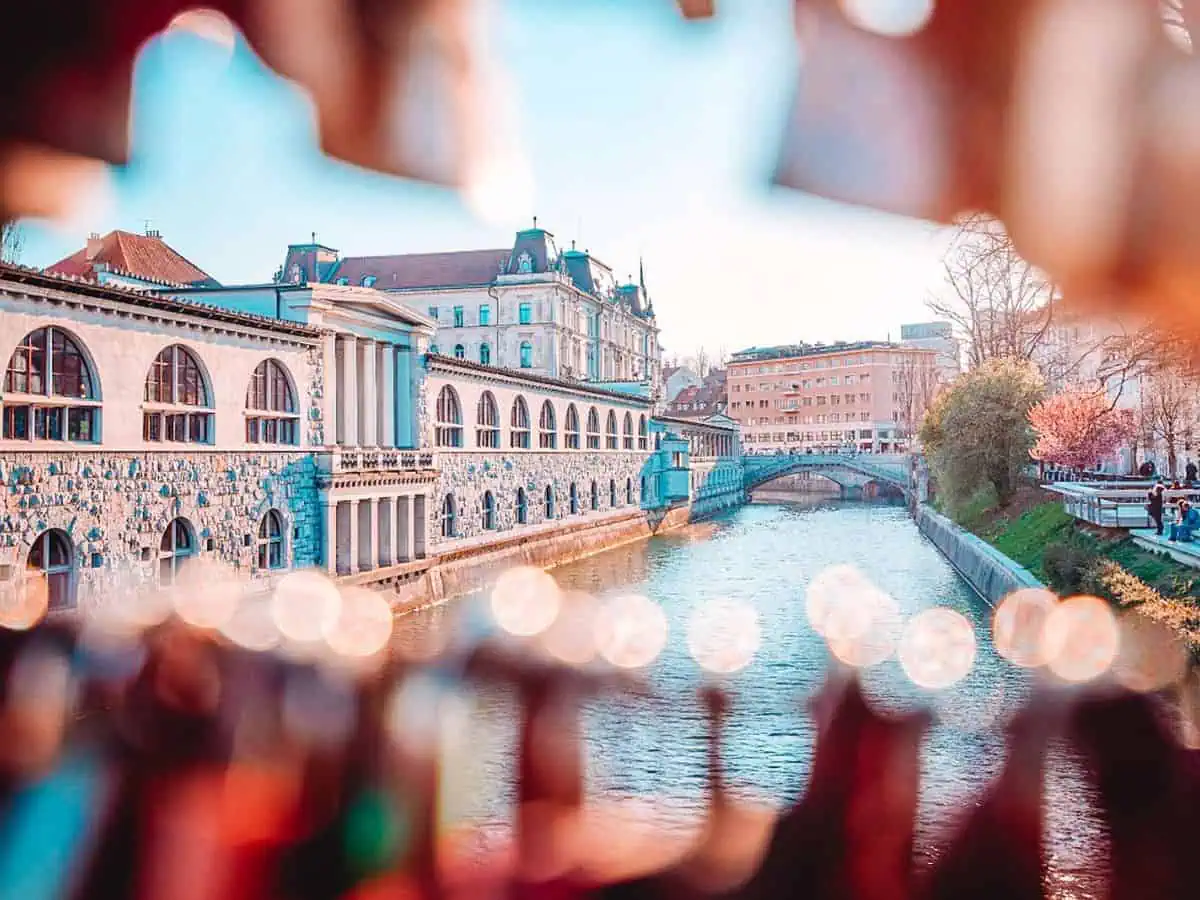 a view of ljubljanica river with old central market and triple bridge from mesarski most aka butchers bridge