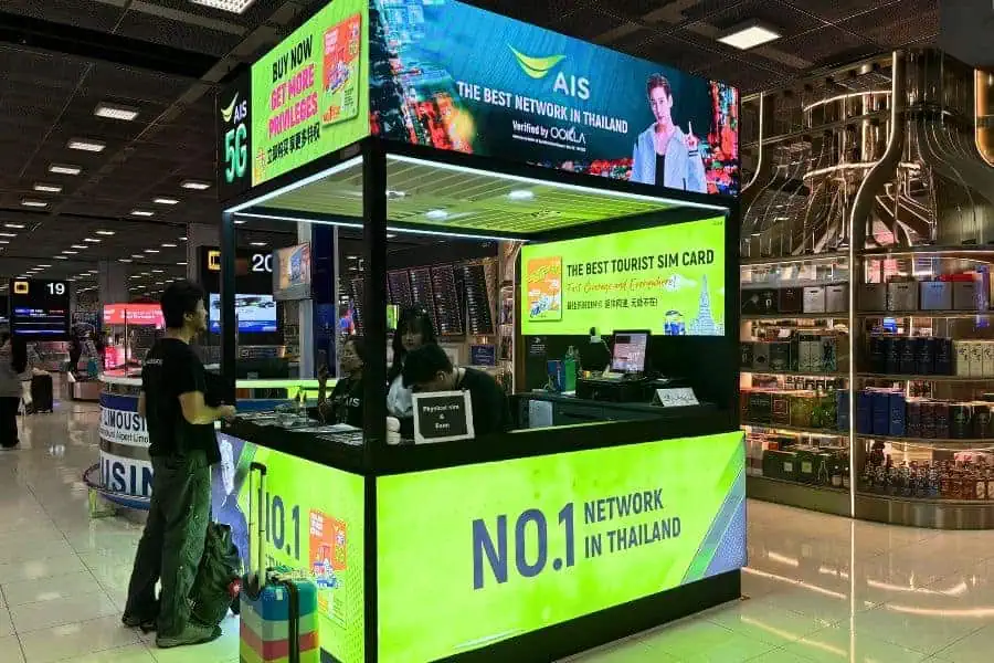 ais mobile carrier booth in a bangkok airport promoting tourist sim cards