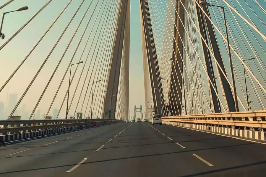 Driving across the Bandra-Worli Sea Link in Mumbai, viewed from inside a car with the cable-stayed bridge's pylons and cables rising overhead