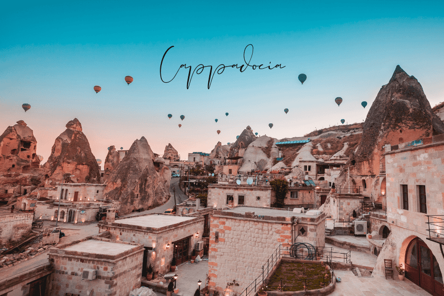 the fairy-tale landscape of cappadocia with cave dwellings, hot air balloons, and rock formations at sunrise