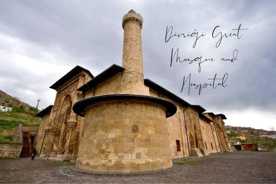 divriği great mosque and hospital, a unesco-listed seljuk architectural masterpiece in turkey, featuring intricate stone carvings and a towering minaret under a cloudy sky