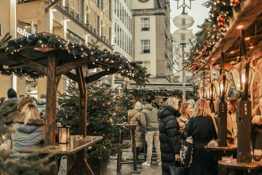 christmas market in european city with wooden stalls and holiday lights