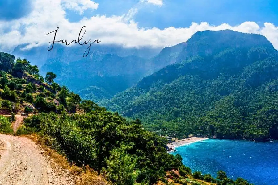 scenic view of faralya with lush green mountains and a turquoise beach