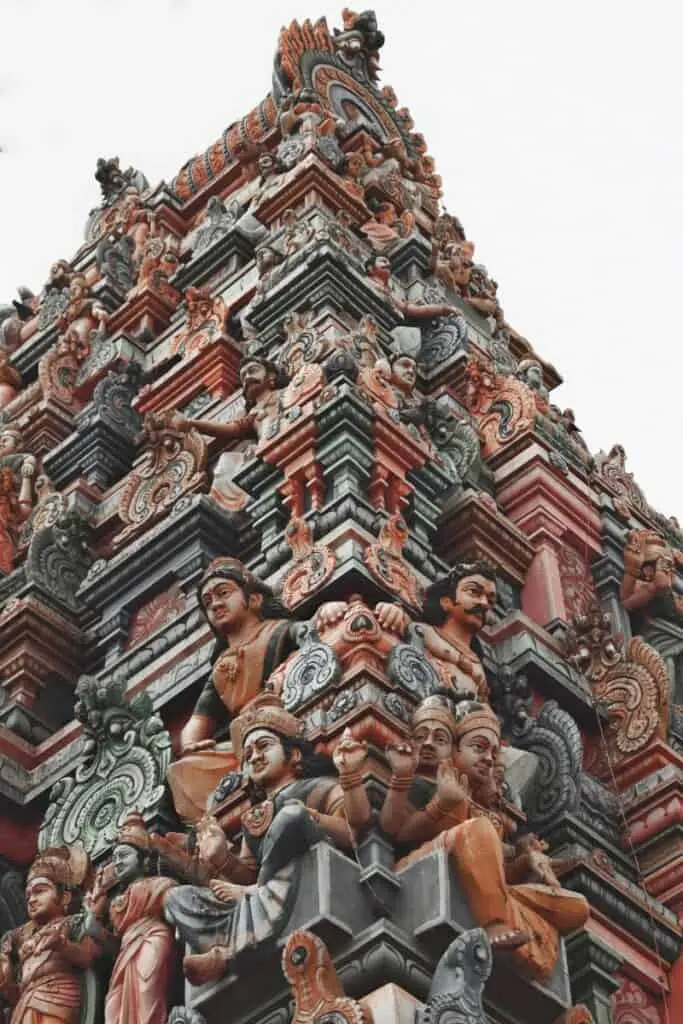 close-up of intricate and colorful carvings on the gopuram (temple tower) of a south indian hindu temple of meenakshi amman temple in madurai, showcasing traditional dravidian architecture