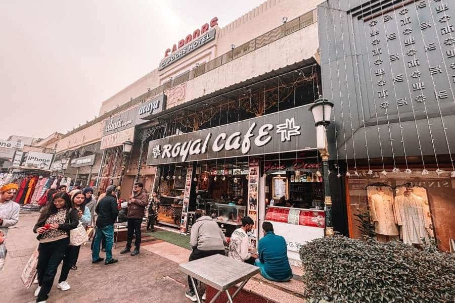 hazratganj street with royal cafe, shops, and people outside, lucknow
