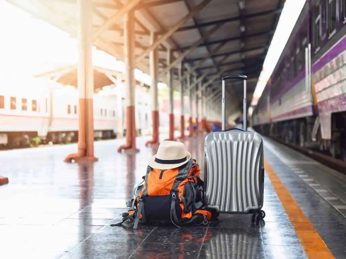 travel luggage and backpack on a chiang mai train station platform, highlighting the end of a family journey from bangkok to chiang mai