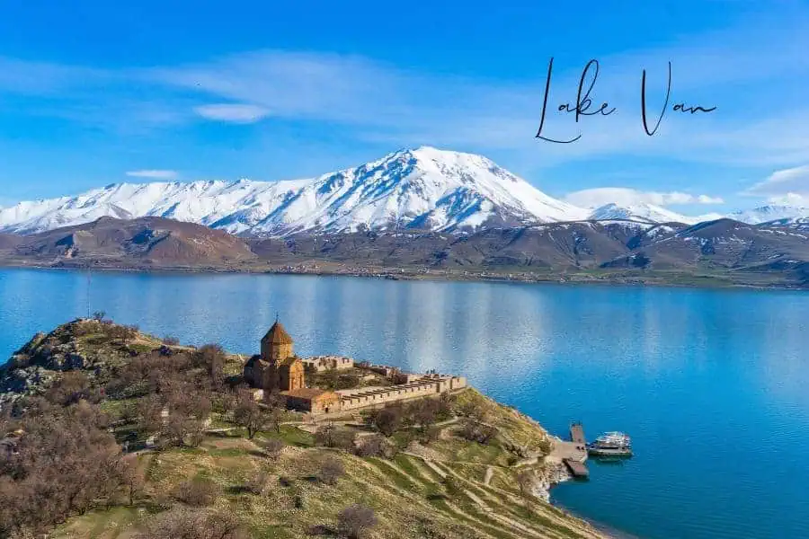 a breathtaking aerial view of lake van in turkey, with the historic akdamar island and its armenian church set against snow-capped mountains