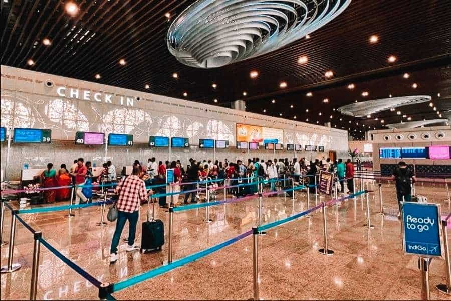 check-in hall at lucknow airport terminal 3 with passengers and airline counters