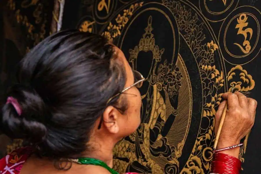 nepalese woman painting a traditional thangka bhaktapur