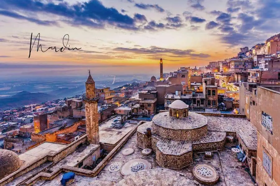 stunning sunset over the old city of mardin with stone buildings and a mosque