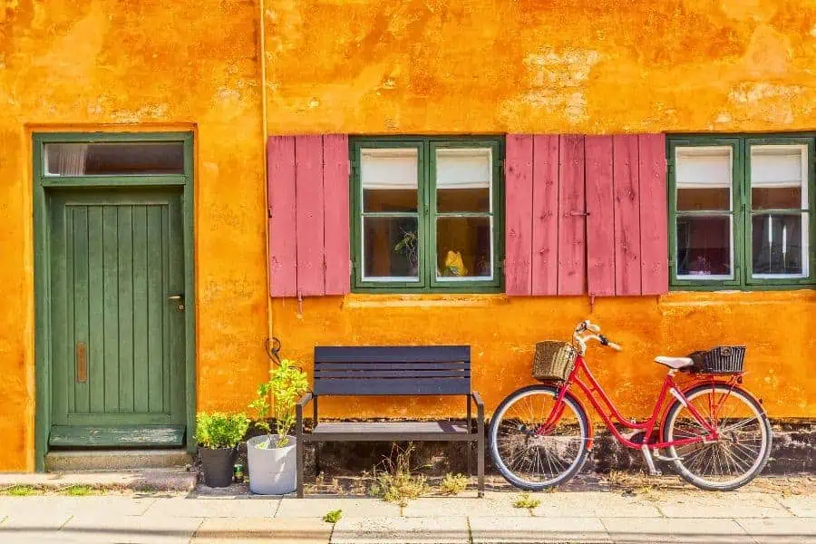 old yellow house with red bike at the historic row house district of nyboder in copenhagen