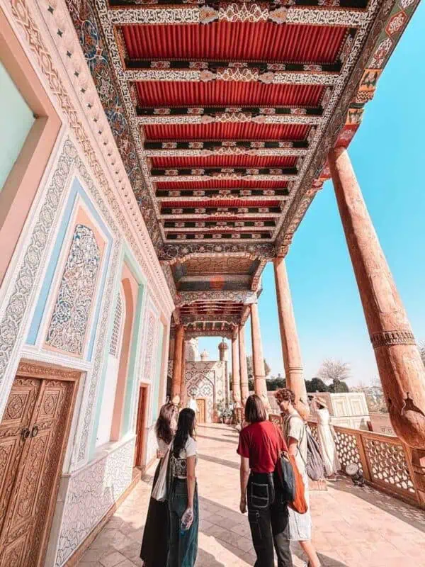 painted wooden ayvan ceiling with carved columns at hazrat khizr mosque