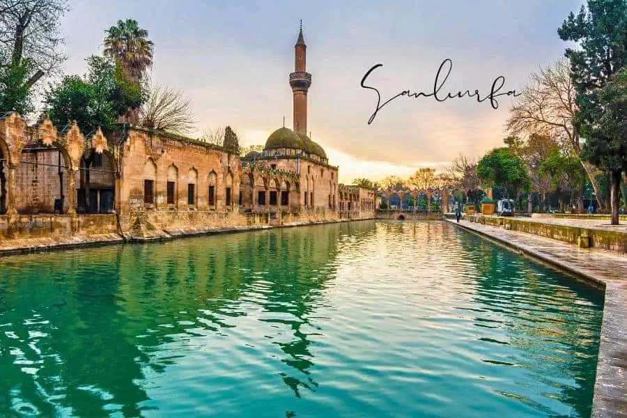 the sacred Pool of Abraham reflecting the golden hues of the historic mosque and ancient stone walls at sunset