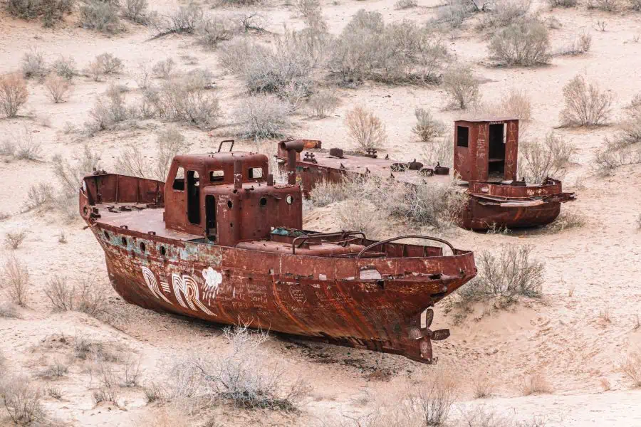 abandoned rusted fishing boats in the aral sea ship graveyard in muynak, uzbekistan