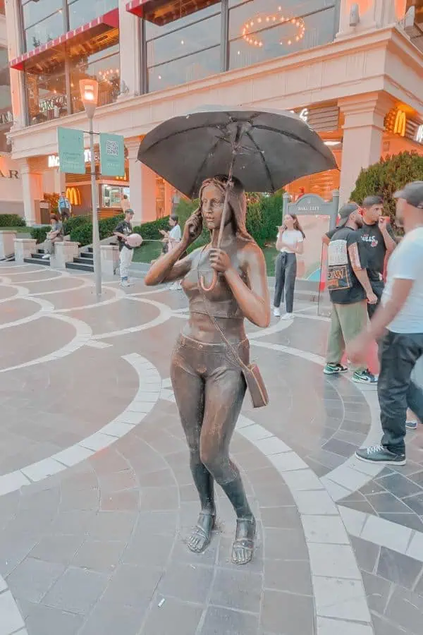 sculpture girl with umbrella nizami street baku itinerary