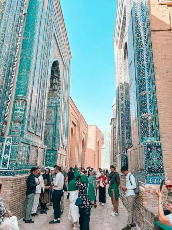 narrow passage between turquoise tiled mausoleums at shakhi zinda samarkand