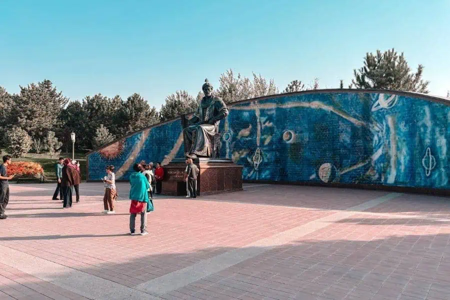 statue of ulugh beg at the observatory complex with celestial mosaic mural in samarkand