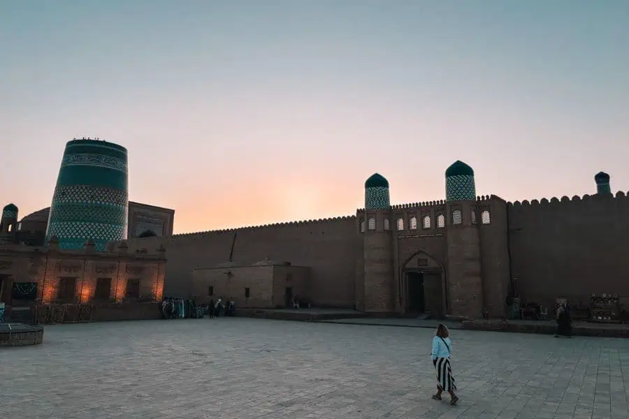 sunset view of itchan kala walls in khiva with west gate ata darwaza and kalta minor minaret in background