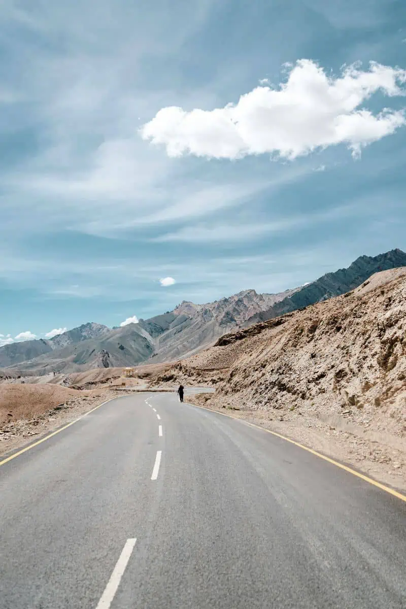 the open road with mountains under the blue sky in ladakh
