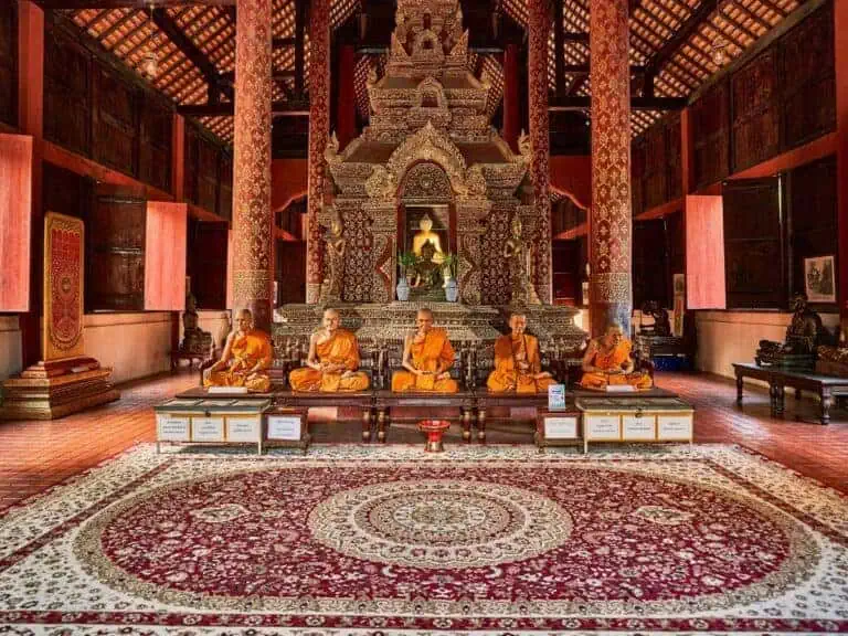 statues of monks that look lke real monks inside ubosot aka ordination hall of wat phra singh in chiang mai