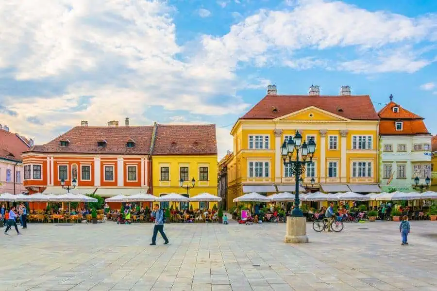 people walking through szechenyi square in gyor hungary
