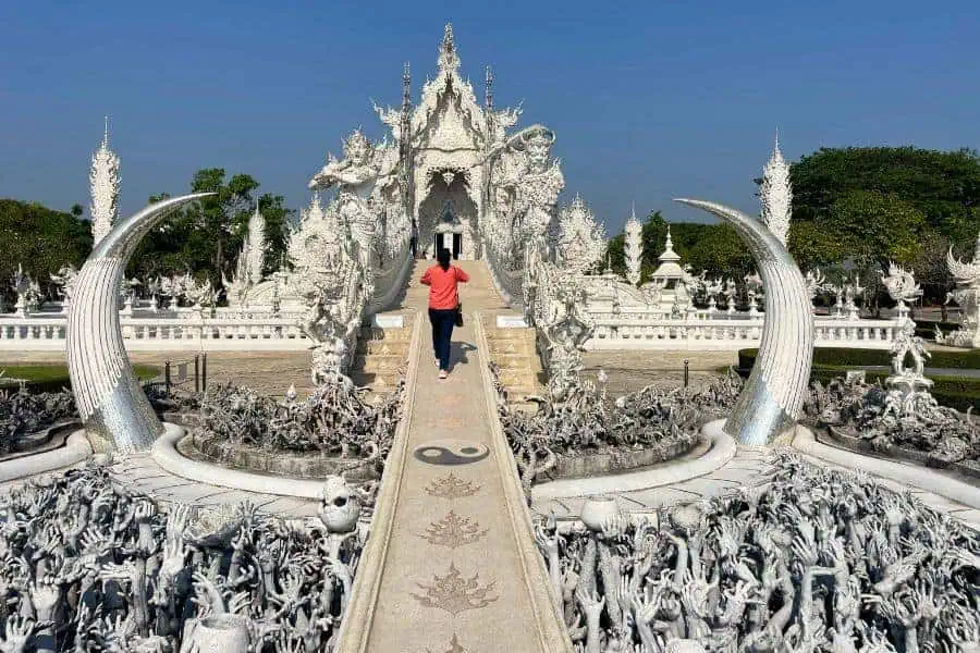 me crossing the bridge to the main temple hall of wat rong khun aka white temple in chiang rai 