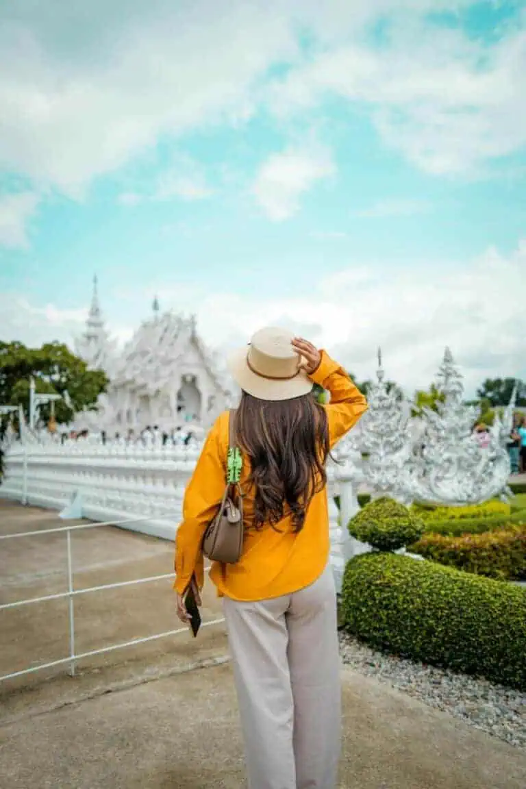 woman admiring white temple in chiang rai thailand